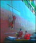 Greenpeace protesters climb onto the Royal Navy supply ship