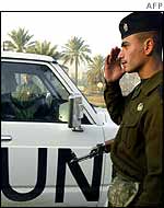 Iraqi soldier salutes as UN vehicle drives past 