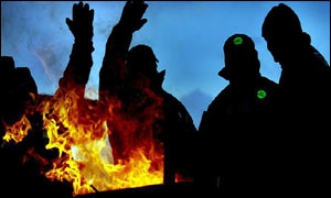 Striking firefighters wave to passing motorists tooting their horns in support , outside the Maryhill fire station in Glasgow 