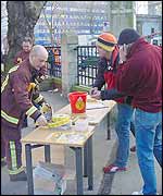 Members of the public sign the firefighters' petition