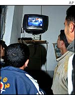 Palestinians in Gaza City watching Israeli election on television