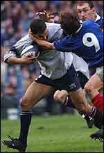 Budge Pountney tries to escape from a head-high tackle from France captain Fabien Galthie