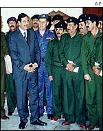 Saddam Hussein with military leaders in Iraq