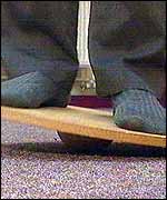 A child balancing on a wobble board