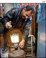 Iraqi man tests a gas lantern
