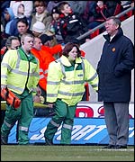 Sir Alex Ferguson looks on as Fabien Barthez is stretchered off