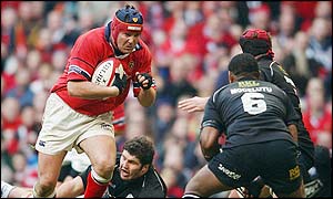 Munster's Anthony Foley runs at the Neath defence during the first half
