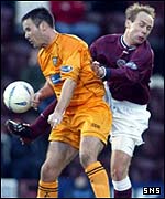 Ged Brannon is challenged by Hearts' Neil Macfarlane