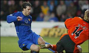 Niemi clashes with Van Nistelrooy and has to be stretchered off the pitch