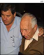 Eliezer Wolferman (right) is comforted 