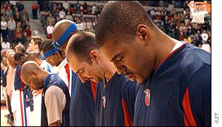 Detroit Pistons basketball players pause in silence