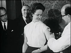 Dr Salk (far left) watches as Margaret Jenkins is vaccinated