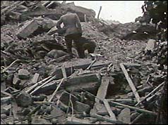 Rescuers dig through the rubble