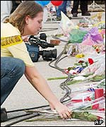 A girl lays flowers in Nacogdoches