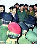 Saddam Hussein with his generals