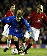 Robbie Savage and David Beckham tangle for the ball
