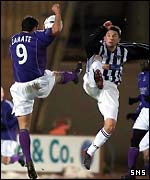 Rolando Zarate and Barry Nicholson challenge