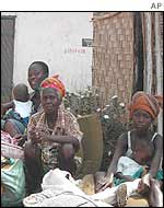 A family rests after fleeing Tubmanburg on Tuesday