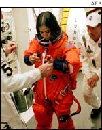 Kalpana Chawla being helped with her launch and re-entry suit