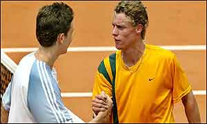 Lleyton Hewitt (R) is congratulated by Alex Bogdanovic of Great Britain 