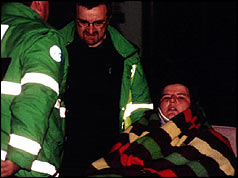 Paramedics take an injured woman to hospital