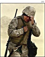 A US marine walks during a sand storm in the Kuwaiti desert on Feb. 3, 2002 