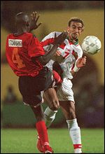 Mozambique's Clodoado Tchabana tackles Morocco's Hadji