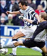 West Brom Daniel Dichio is brought down by Bolton keeper Jussi Jaaskelainen