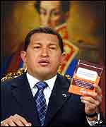 Hugo Chavez on TV with portrait of Simon Bolivar in the background