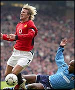 Manchester City's David Sommeill challenges David Beckham