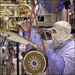 Engineer finishes the assembly of one of two Mars rovers inside a clean room at the Spacecraft Assembly Facility in Pasadena, California