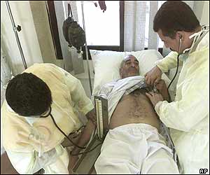 Saudi Arabian medical workers giving first aid to a pilgrim who was suffering from exhaustion 