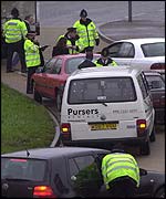 Police checking cars in a village near Heathrow