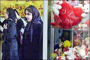 Iranian women pass as a shop displaying Valentine's day hearts and toys in the capital, Tehran.