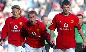 A dejected Man Utd skipper Roy Keane (right) is followed off the pitch by Nicky Butt and Diego Forlan