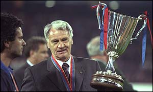 Robson holds the European Cup Winners Cup aloft as manager of Barcelona in 1997 