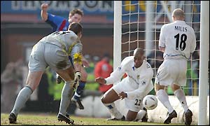 Leeds Michael Duberry and Danny Mills scramble Tommy Black's effort clear