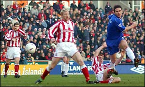 Chelsea's Frank Lampard fires in a shot under pressure from the Stoke defence