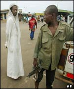 A man looks disapprovingly at a young rebel in Bouake