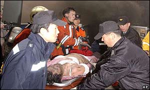 Emergency workers bring out a casualty on a stretcher