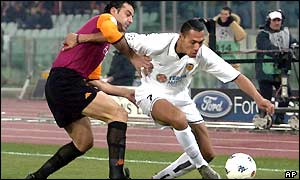Traianos Dellas of Roma vies for possession with Valencia's John Carew