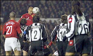 Wes Brown rises to head the ball in the Juventus penalty area