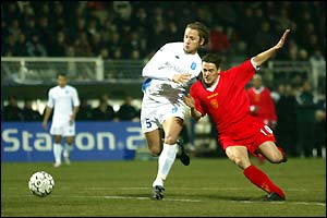 Michael Owen and Philippe Mexes contest the ball in the first half