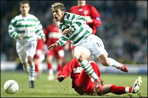 Stuttgart's Marcelo Bordon's tackle sends Celtic's Stilian Petrov flying