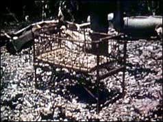 Remains of a child's cot in a bombed Cambodian village