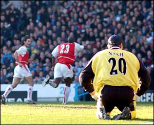 Man City goalkeeper Carlo Nash sits dumbfounded after letting in a fourth Arsenal goal