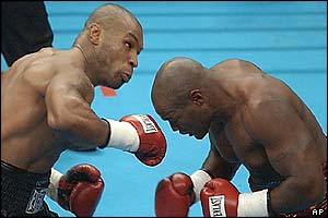 Mike Tyson gets ready to land an uppercut on Clifford Etienne