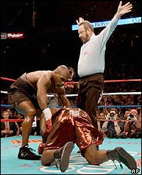 Mike Tyson helps Clifford Etienne to his feet