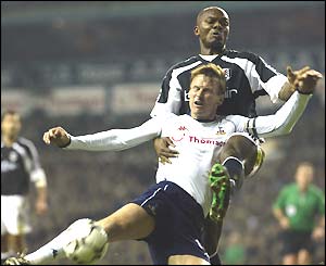 Spurs' Teddy Sheringham and Fulham's Pierre Wome jump for a high ball together