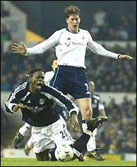 Louis Saha is fouled by Darren Anderton of Tottenham